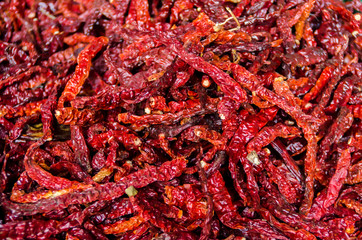 Fototapeta premium Dry peppers - Red chilies background - Selective focus 