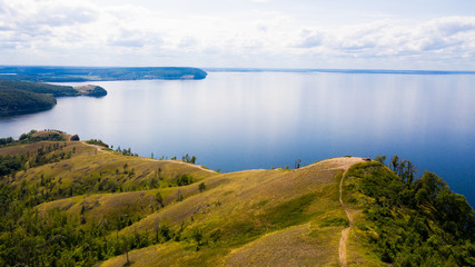  Aerial view from the drone of landscape Volga river flows among the hills and fields. The middle band of Russia.