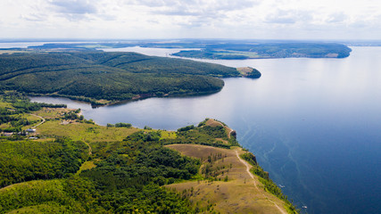  Aerial view from the drone of landscape Volga river flows among the hills and fields. The middle band of Russia.
