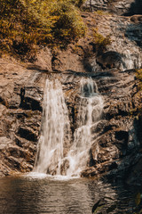 Fototapeta na wymiar A multi level waterfall and cascade in a tropical rainforest, lampee waterfall in Phannga ,Thailand