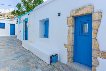Street view of Potamos village with narrow alleys and traditional architecture in Antikythera island in Greece