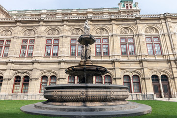 Fototapeta na wymiar Fountain near Vienna State Opera in Vienna, Austria