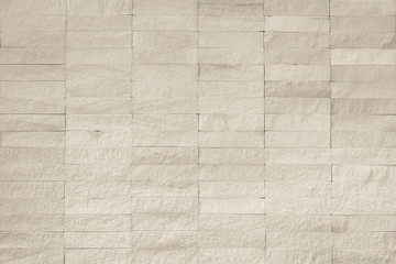Rock stone tile wall texture rough patterned background in sepia white color