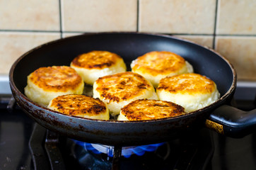 Cheesecakes curd frying and old pan. Photo