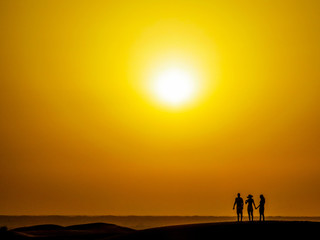 People Silhouette in the Desert at Sunset