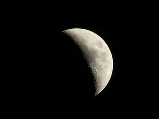 Half moon - Close up of a half moon Waxing Gibbous against dark sky