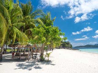 Fototapeta premium Philippines, november 2018: White sand beach near the rocks and boats.Palawan,Busuanga,Tropical beach for tourists aerial view