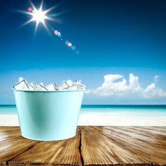 Desk of free space for your decoration and summer beach background with ice cubes 