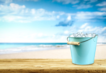 Desk of free space for your decoration and summer beach background with ice cubes 