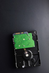 Isolated computer hard drive on black matte background. Data storage concept