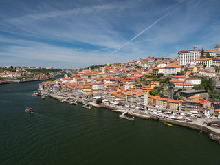 Fototapeta na wymiar Portugal, June 2019: Porto Cityscape over Douro River and medieval Ribeira district, Portugal. One of the oldest European centres, its historical core was proclaimed a World Heritage Site by UNESCO.