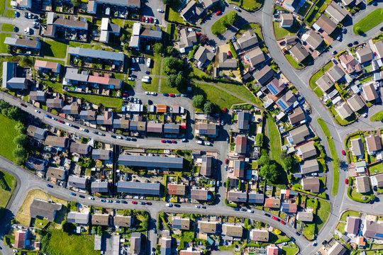 Aerial drone view of small winding sreets and roads in a residential area of a small town