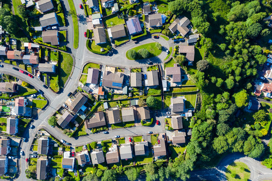 Aerial drone view of small winding sreets and roads in a residential area of a small town