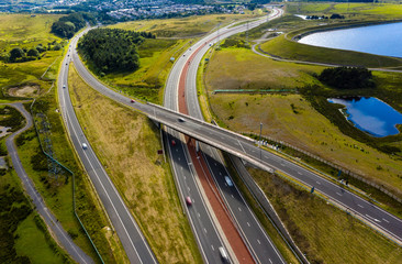 Aerial drone view of a large, new dual carriageway road with motion blurred vehicles (A465, Wales, UK) - obrazy, fototapety, plakaty