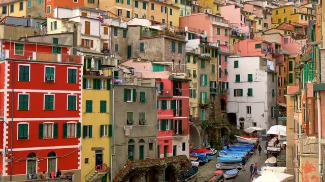 Colorful houses in Riomaggiore, Italy. Townscape background. Riomaggiore is one of the Cinque Terre towns and a popular tourist destination. Tilt shot, UHD