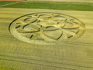 Fototapeta na wymiar Canton Bern, Switzerland - July 05, 2019: mysterious crop circle emerged overnight in wheat field with beautiful pattern.