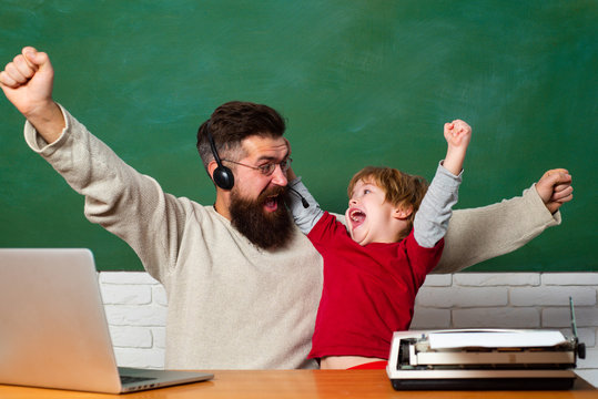 School children. Hurray. Father and son. Child showing winner sign. Chalkboard ready for text