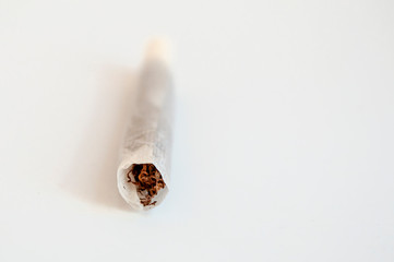 Clean up front shoot of handmade single cigarette horizontal positioned