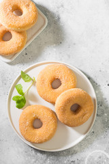 Doughnuts with sugar sprinkles. Light grey background