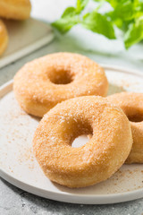 Doughnuts with sugar sprinkles. Light grey background