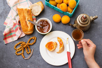 breakfast with apricot jam and slice of bread, arabic tea