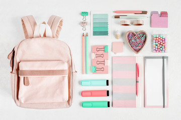 Backpack with school supplies and books for study. Back to school concept. Flat lay, top view