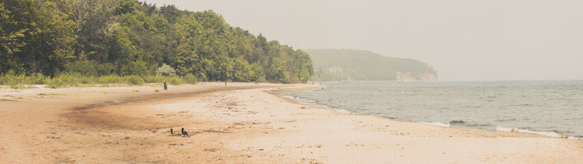 Panoramic view of empty sandy beach in summer day. Vacation over Baltic sea.