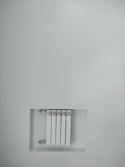 heating battery on a white wall