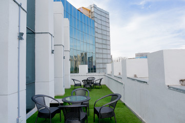 Fototapeta na wymiar Outdoor seating space in a building with artificial grass and seats