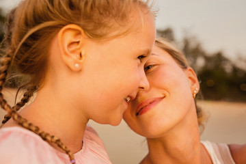 Mother and adult daughter are doing Selfie on the beach. Smiling mother and daughter posing together to take a selfie. Mommy with Girl. Happy and positive emotions