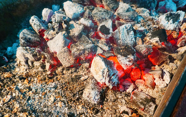 Burning hot coals in fire near die out ater cooking,selective focus,smoldering charcoal