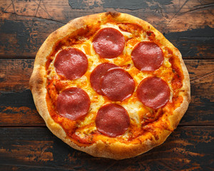 Pepperoni, Salami Pizza on wooden table. ready to eat