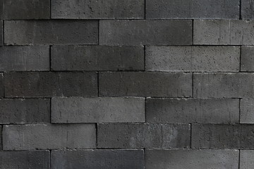 simple black stone brick wall pattern for industrial and minimalism wallpaper and background design