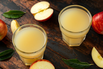 Apple juice in glass on rustic wooden table