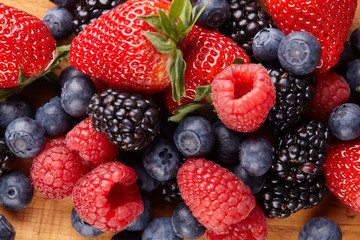 Various fresh summer berries. Ripe strawberries, blackberries, blueberries, raspberries. Top view. Background berries and fruits