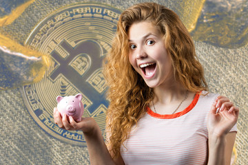 Young red-haired curly girl holding piggy bank and rejoices gesturing. The concept of reliability of cash investments and insurance.