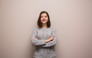 Portrait of young brunette girl in grey sweater 