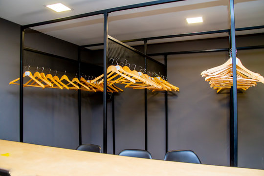 bright wooden hangers with numbers in empty cloakroom or checkroom or wardrobe