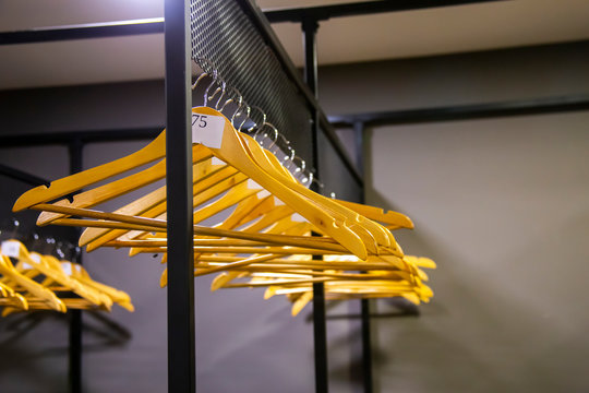 bright wooden hangers with numbers in empty cloakroom or checkroom or wardrobe