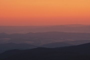 Mountain nature landscape panorama with silhouette layers and valley view at sunset colorful sky. Wolfswarte, Torfhaus, National Park Harz in Germany