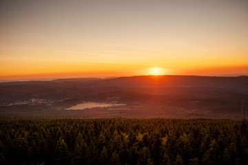 Mountain nature landscape panorama with silhouette layers and valley view at sunset colorful sky. Wolfswarte, Torfhaus, National Park Harz in Germany