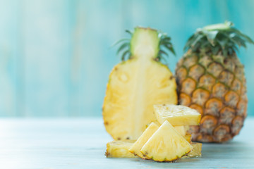 Fototapeta na wymiar Ripe pineapples summer tropical fruits on pastel turquoise background. Summer fruit concept