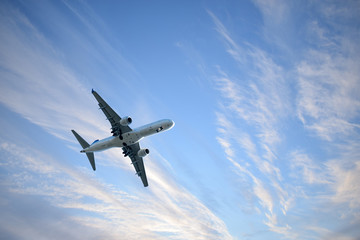 Passenger plane against the sky with clouds.