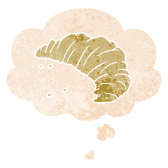 cartoon croissant and thought bubble in retro textured style