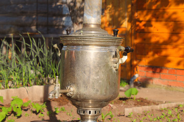 Old Russian samovar in the garden. Close-up. Background.