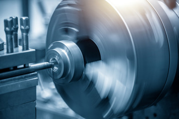 The lathe machine bore cutting the metal ring. The metal working process with the turning machine.