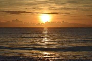 Fototapeta na wymiar Sunrise over clouds and ocean