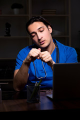 Young male doctor in the hospital at night 