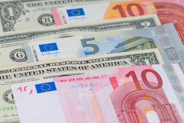many different american dollars and european union euro banknotes close-up shot