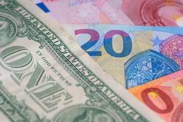 many different american dollars and european union euro banknotes close-up shot